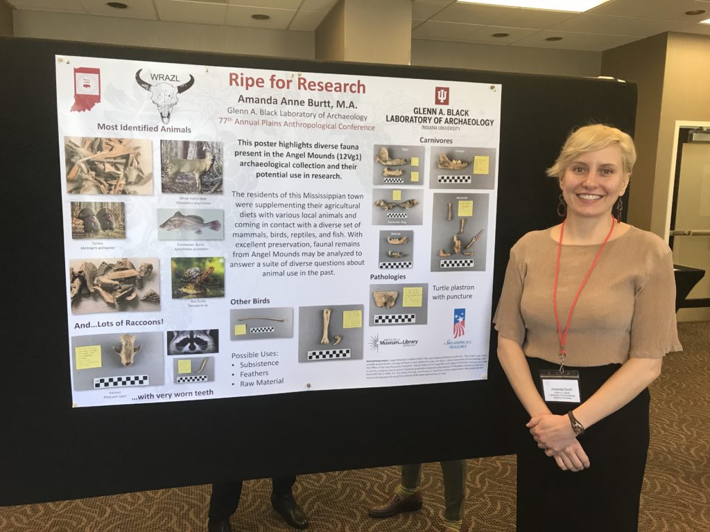 Amanda stands next to her poster "Ripe for Research"